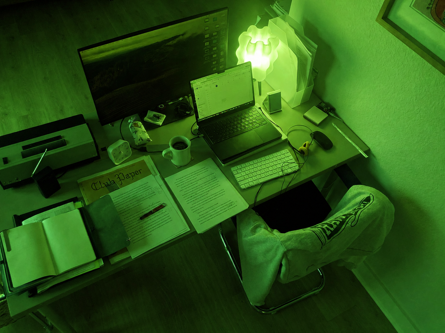 A dithered image of the silhouette of a human gently levitating above the ground, their heart chakra glowing green, set against a background of a large glowing HTML Energy orb of light.